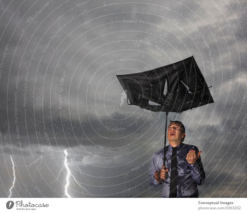 Businessman caught in a storm Anticipaction Anxiety Broken Challenge Conceptual Conquering adversity Damaged Danger Determination Difficult Digital composite