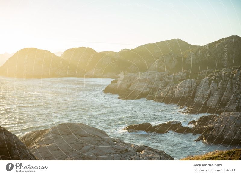 Serene Scandinavian summer landscape on south coast of Norway. Rocky Mountains, fjord from top. Sunset sky. Lindesnes Adventure Bay Beauty Photography Coast