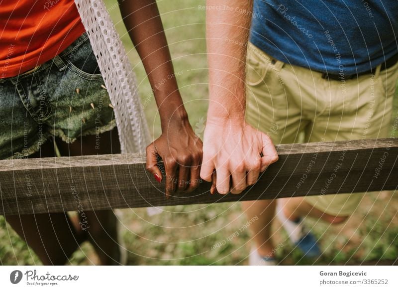 Multiracial couple in the park Lifestyle Summer Human being Woman Adults Man Couple Arm Hand Wood Together Modern Black boyfriend casual Caucasian diversity