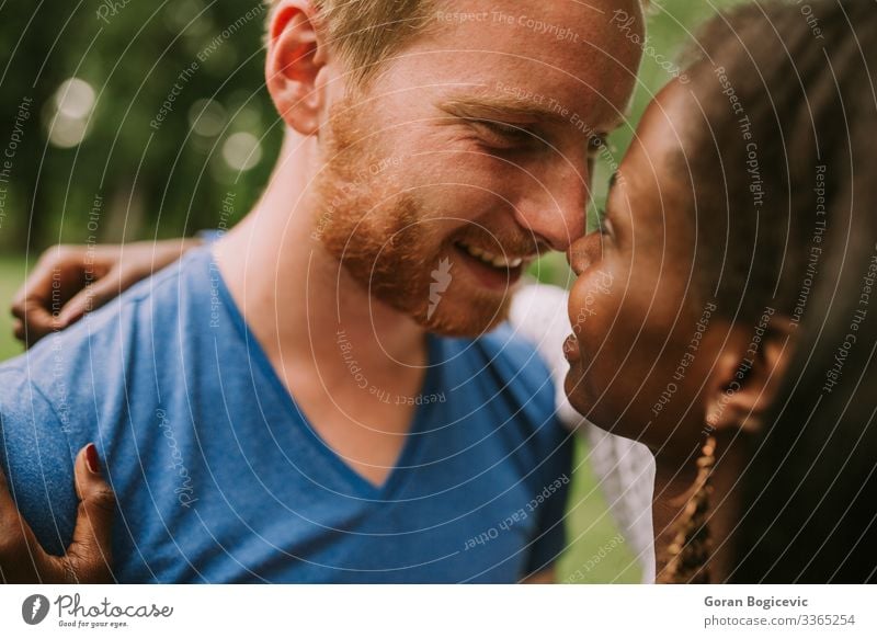 Multiracial couple in the park Lifestyle Summer Human being Woman Adults Man Couple 2 18 - 30 years Youth (Young adults) Red-haired Together Modern Black