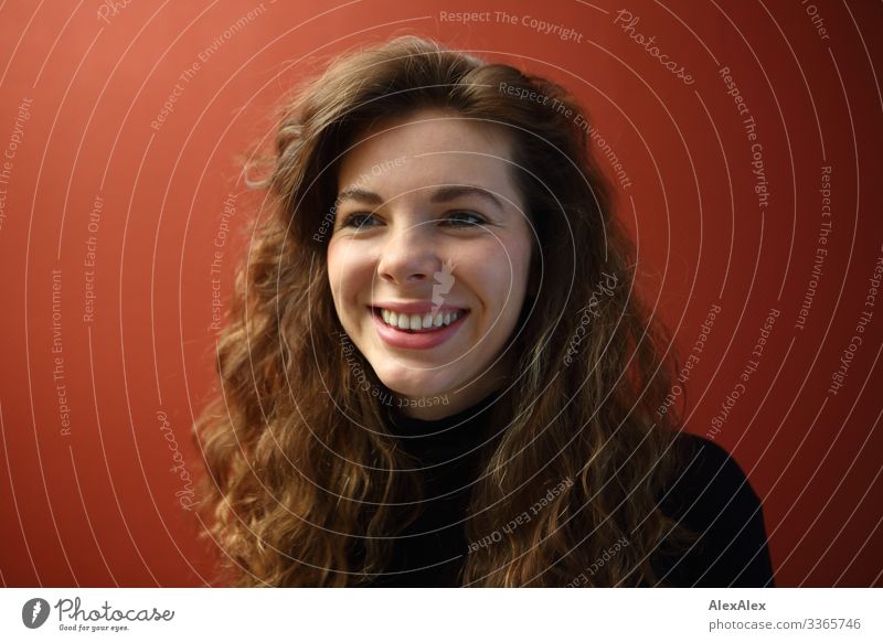 Portrait of a smiling young woman with dimples in front of a red wall Elegant Joy already Life Well-being Flat (apartment) Young woman Youth (Young adults) Face