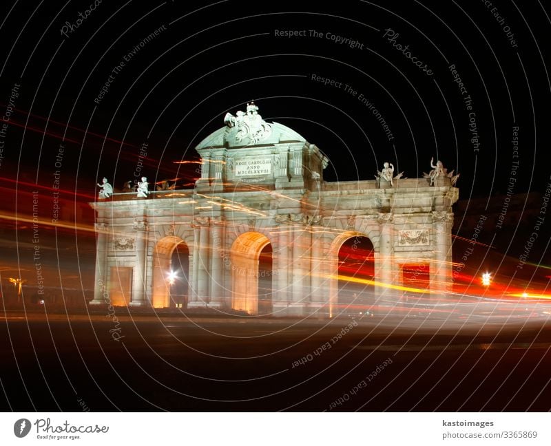 Puerta de Alcala, Madrid, Spain at night. Vacation & Travel Tourism Art Sky Building Architecture Monument Transport Street Car Stone Old Historic Blue Yellow
