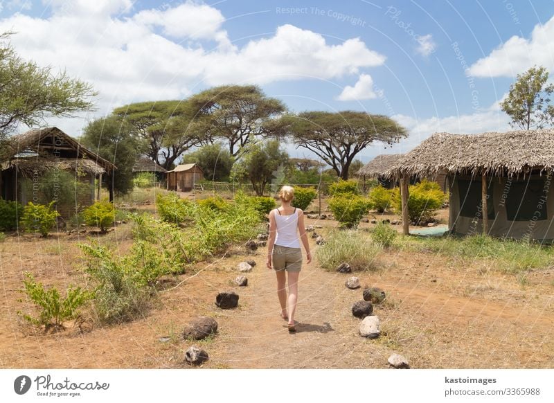 Caucasian woman traveling in Africa huts Vacation & Travel Exterior shot Landscape Nature safari rear view summer Safari Adventure Trip Tourism Summer trees sky