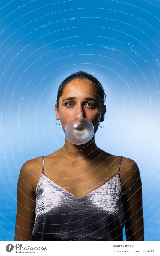 Studio Portrait of Young Indian Woman Blowing Bubble Gum Bubble gum chewing gum blowing up bubble female girl woman young adult female beauty beautiful woman