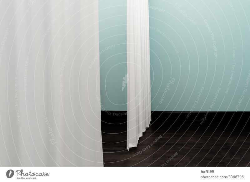 two curtains in the room in front of a turquoise coloured wall Museum Stage Building Wall (barrier) Wall (building) Drape Stage set Esthetic Simple Elegant