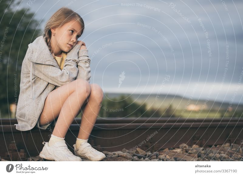 Portrait of young sad girl sitting outdoors on the railway at the day time. Concept of sorrow. Face Child Human being Woman Adults Family & Relations Infancy