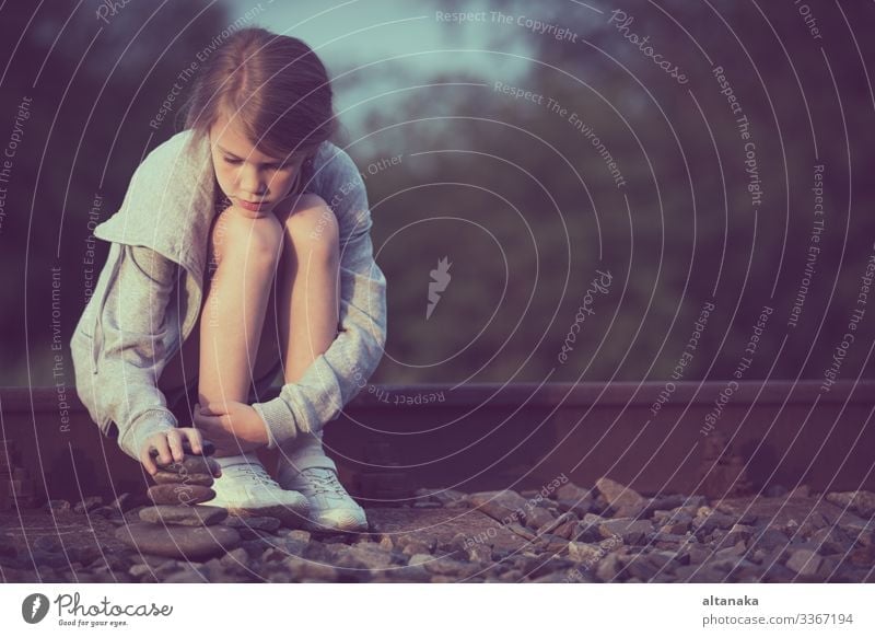 Portrait of young sad girl sitting outdoors on the railway at the day time. Concept of sorrow. Face Child Human being Woman Adults Family & Relations Infancy