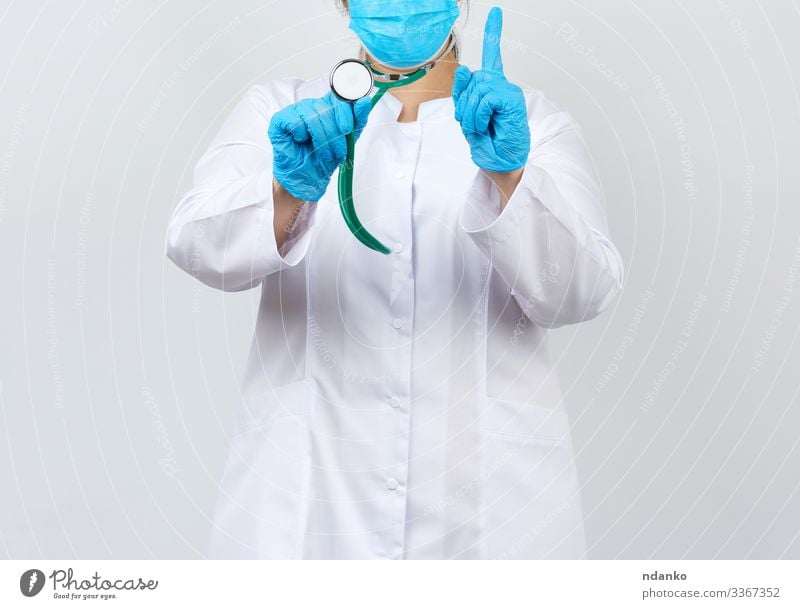 Female doctor in a white coat wearing hair bonnet and mouth guard