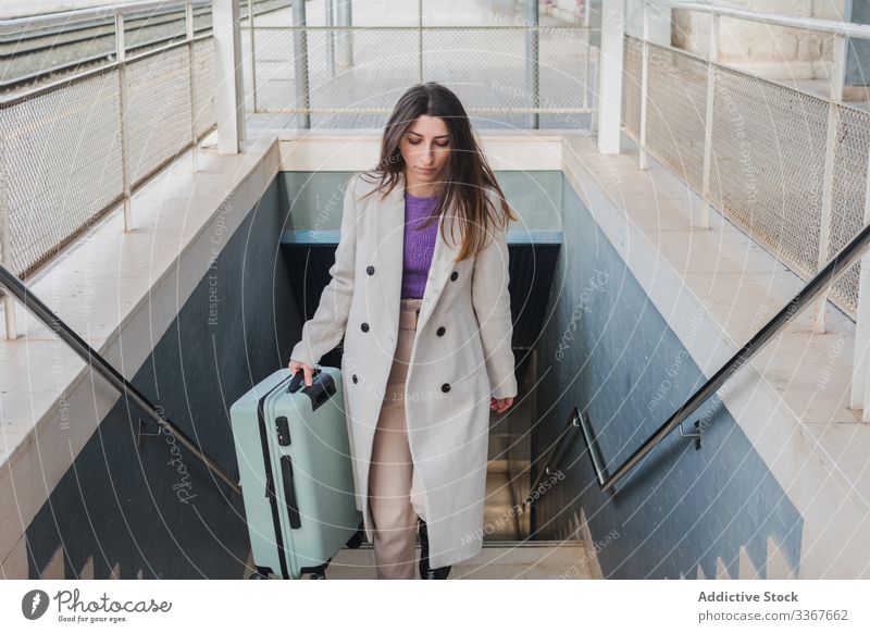 Woman with suitcase walking up stairs woman travel station climb upstairs holiday city young transportation trip passenger female trendy destination transit