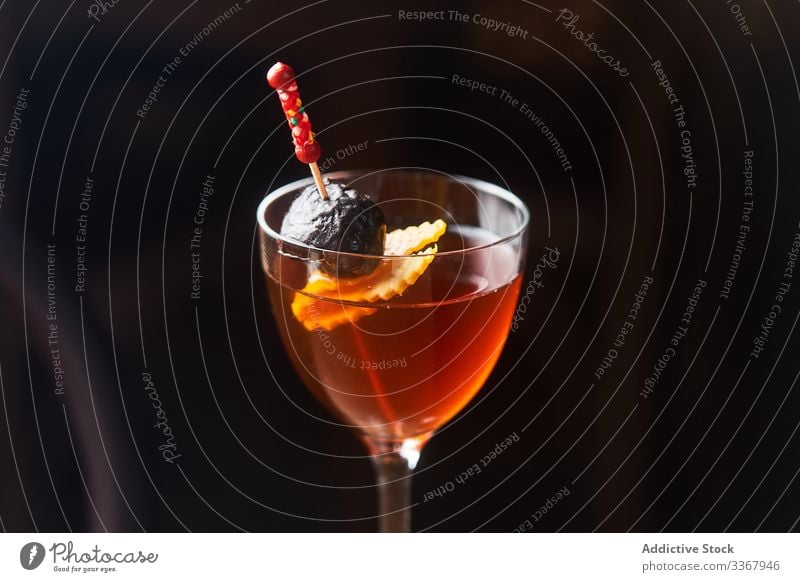 Manhattan cocktail with garnish on dark background alcohol classic manhattan drink red bourbon vermut glass bar cold luxury aperitif food fresh orange liquid