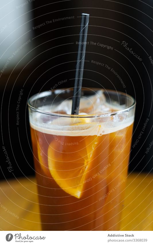 Coffee cocktail with lemon in restaurant ice cold coffee bean slice tube drink beverage yellow juice fresh mint decorated served cafe glass alcohol bar