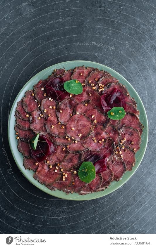 Plate with tasty carpaccio in cafe meat raw slice plate restaurant beetroot exquisite cold gourmet appetizer dish food delicious yummy dinner red vegetable thin