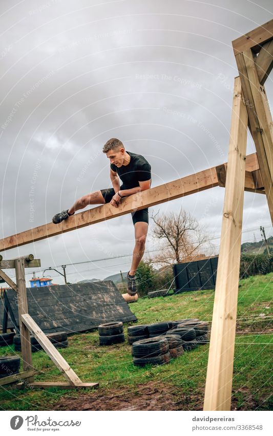 Male in obstacle course doing irish table Lifestyle Sports Human being Man Adults Wood Authentic Strong Power Effort Competition obstacle course race overcoming