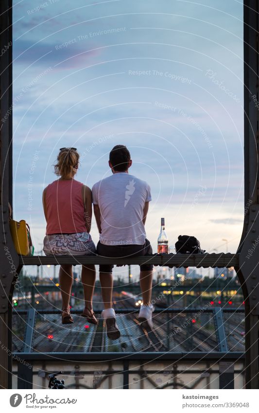 Couple on romantic date on railway bridge, Munich, Germany. Bottle Lifestyle Joy Beautiful Vacation & Travel Summer Woman Adults Man Skyline Bridge Street