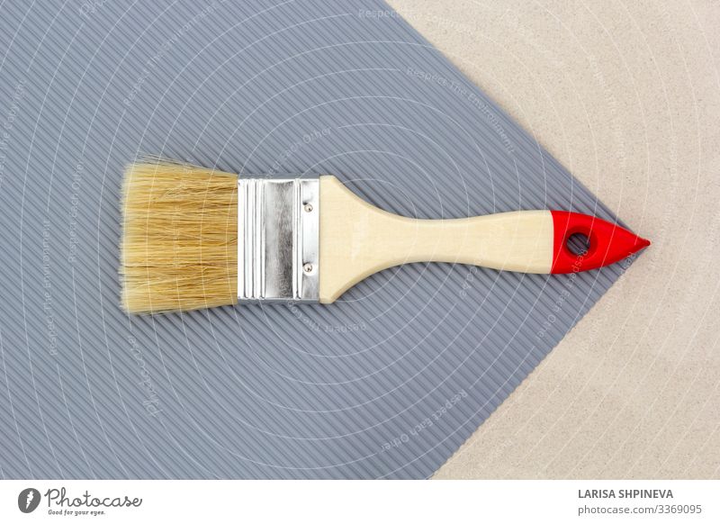 Paint brush for repair on gray background. Top view. Design House (Residential Structure) Decoration Work and employment Tool Hand Art Gloves Tin Wood Metal