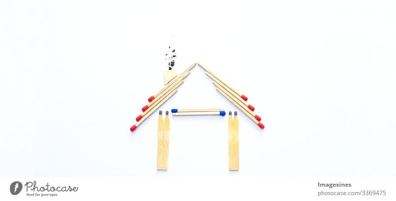 fire insurance, shape of the house made of matches. abstract house made with matches on white paper background. Concept of home protection insurance with the importance of smoke detectors