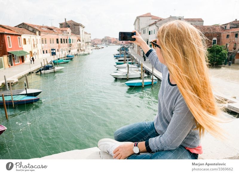 Young woman taking a photo on the bridge in Murano in Venice, Italy Lifestyle Joy Vacation & Travel Tourism Trip Adventure Freedom Sightseeing City trip