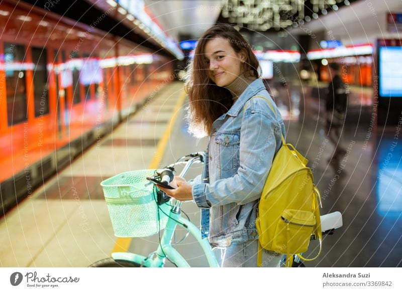 Teenager girl with backpack and smartphone on metro station Decoration Blog Internet Easygoing Casual clothes Chat Chatty City Destination Europe Finland