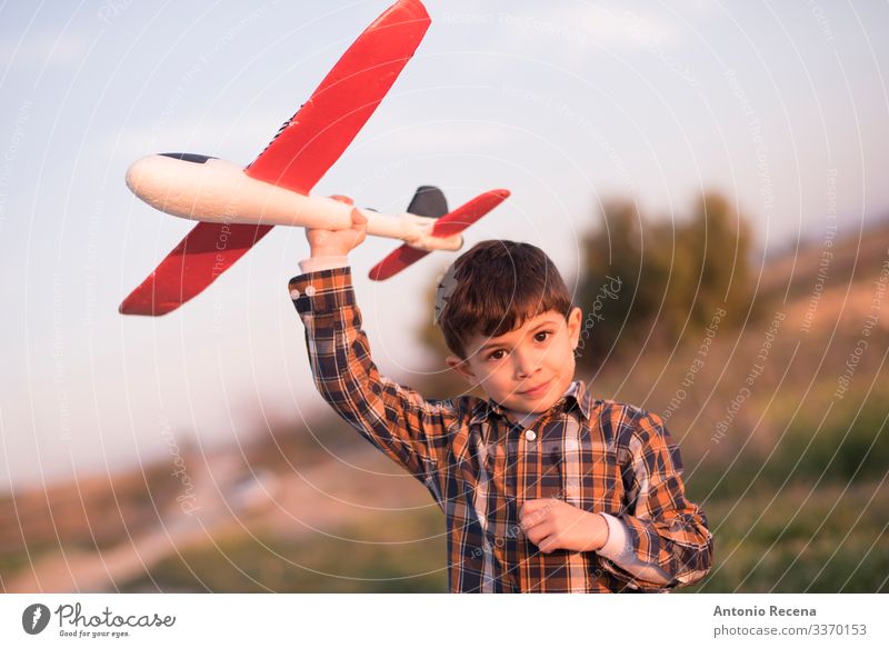 Plane boy Playing Vacation & Travel Adventure Child Pilot Boy (child) Infancy Flower Meadow Street Airplane Toys Flying Speed Sunset plaid shirt kid handsome