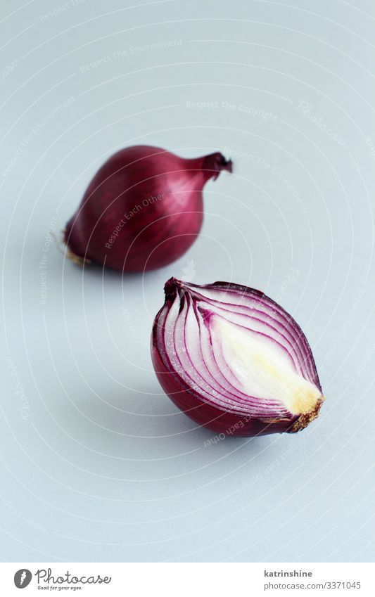 Purple onion on a light grey background Vegetable Vegetarian diet Fresh Natural Gray Red White Onion Sliced Half food healthy Raw Organic Ingredients Mature