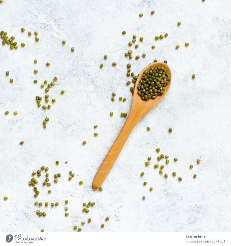 Dried mung beans with a spoon on a white background Vegetarian diet Diet Spoon Table Above Green White Beans fiber food health healthy Ingredients Kidney legume
