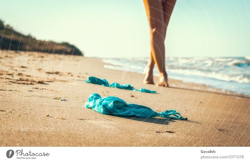 little girl stands on beach in a special swimsuit for children who can not  swim. child in swimsuit, which he kept afloat - a Royalty Free Stock Photo  from Photocase