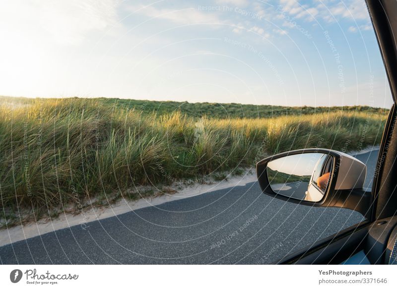 Car window view with grassy dunes and road on Sylt island Vacation & Travel Tourism Trip Summer Mirror Landscape Grass Street Driving Perspective Germany