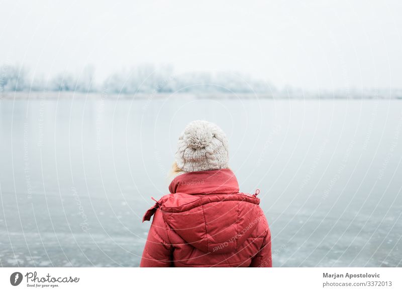 Woman looking at a frozen lake in winter morning Lifestyle Adventure Freedom Winter Human being Feminine Young woman Youth (Young adults) Adults 1 30 - 45 years