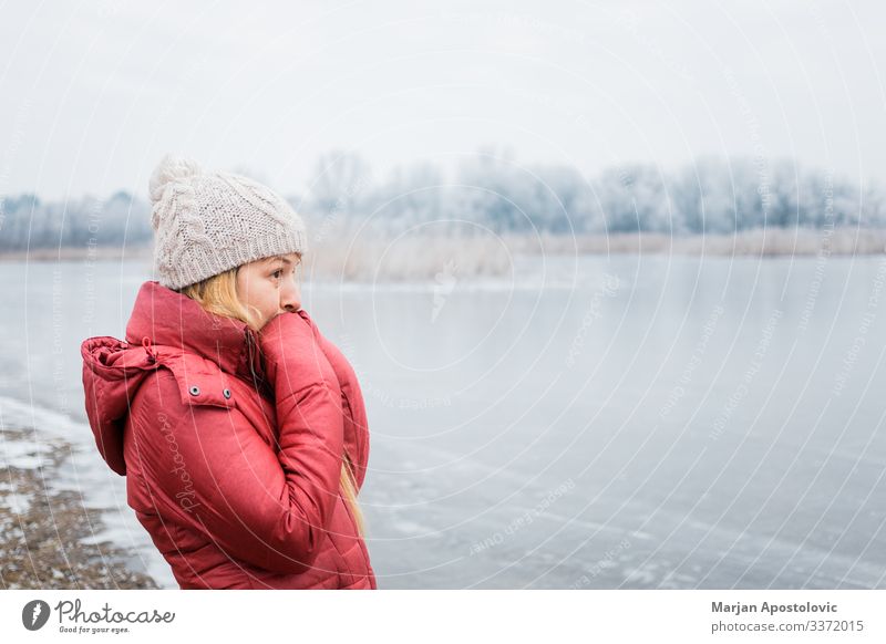 Young woman standing by the frozen lake in winter Lifestyle Adventure Winter Hiking Feminine Youth (Young adults) Woman Adults 1 Human being 30 - 45 years