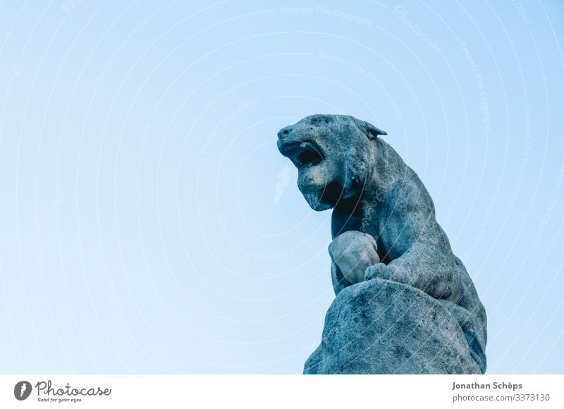 Sculpur mythical creature made of stone in front of a blue sky Animal portrait Contrast Shadow Light Day Neutral Background Colour photo Ancient