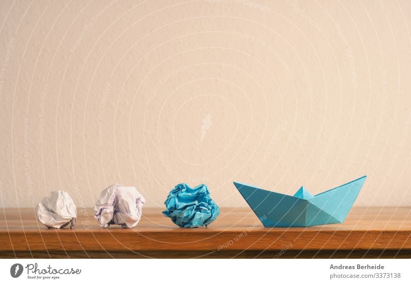 New ideas or teamwork concept with crumpled paper and paper boat background blue business color compass competition copy space creative creativity difference