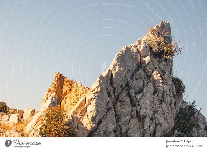 warm illuminated rock in front of a blue sky Back-light Sunbeam Contrast Shadow Light Day Deserted Exterior shot Colour photo Adventure Hiking