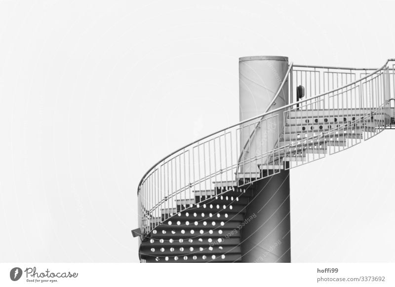 Profile of a spiral staircase with fine-linked banister and visible perforated undersides of the steps Clouds Bad weather Architecture Manmade structures Town