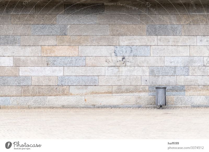 Garbage can in front of sandstone wall with fading graffito Diagonal Wall (building) Brick Minimalistic Pecking order Stagger Stairs Approach to the stairs