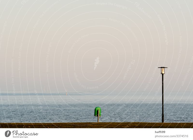 minimalistic view of lantern with garbage can at the sea Nature Water Cloudless sky Sunrise Sunset Spring Summer Beautiful weather Grass Coast North Sea