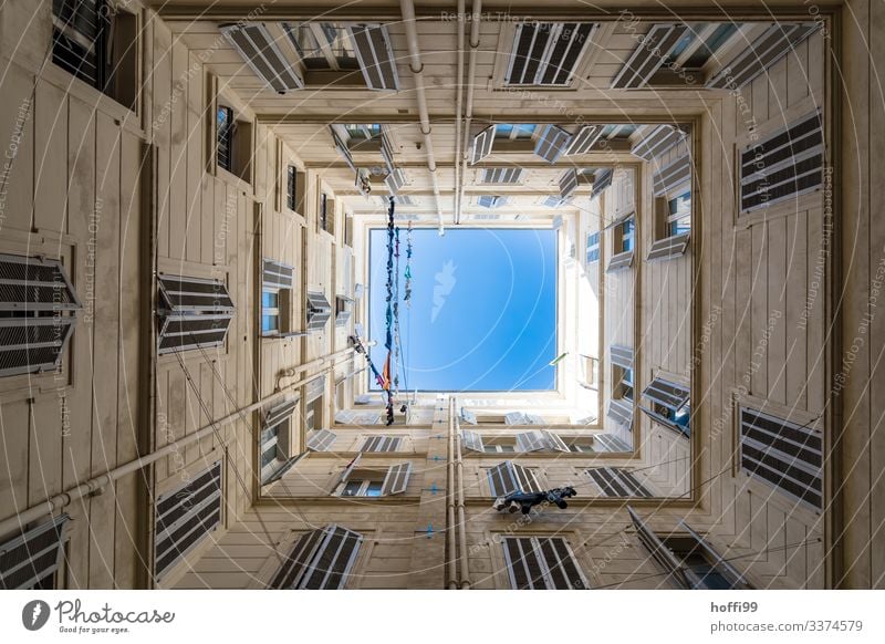 View up in a square courtyard with clotheslines and a deep blue sky Beautiful weather House (Residential Structure) Interior courtyard Wall (barrier)