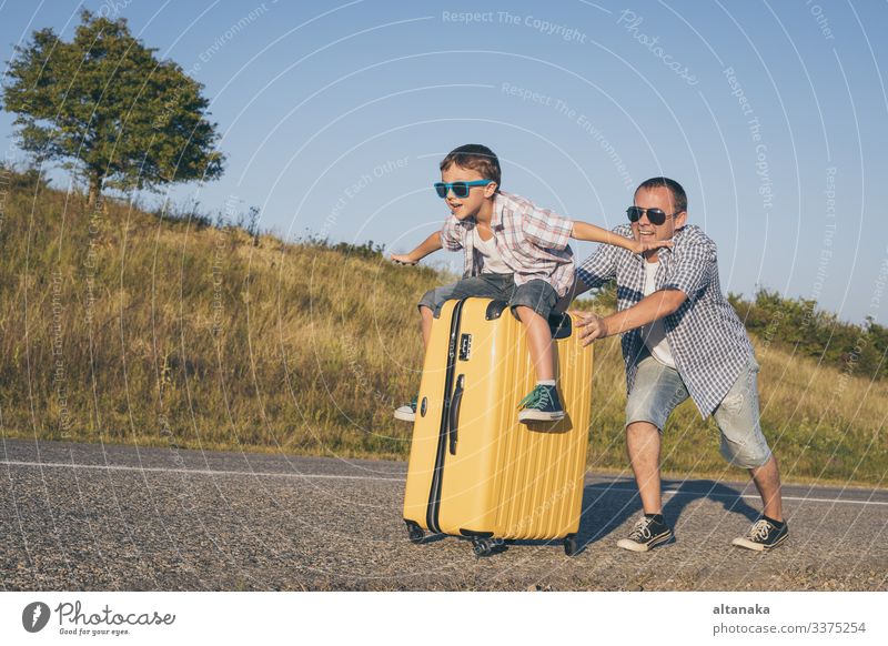 Father and son playing on the road at the day time. People having fun outdoors. Concept of happy vacation and friendly family. Lifestyle Joy Happy Playing