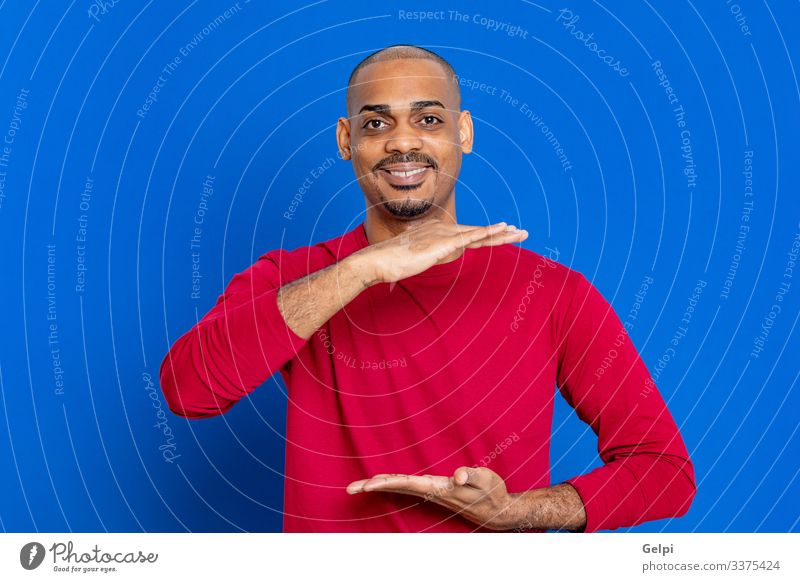African man with red T-shirt Hair and hairstyles Human being Man Adults Hand Fingers Afro Blue Red Black White Colour Guy point Indicate indicating