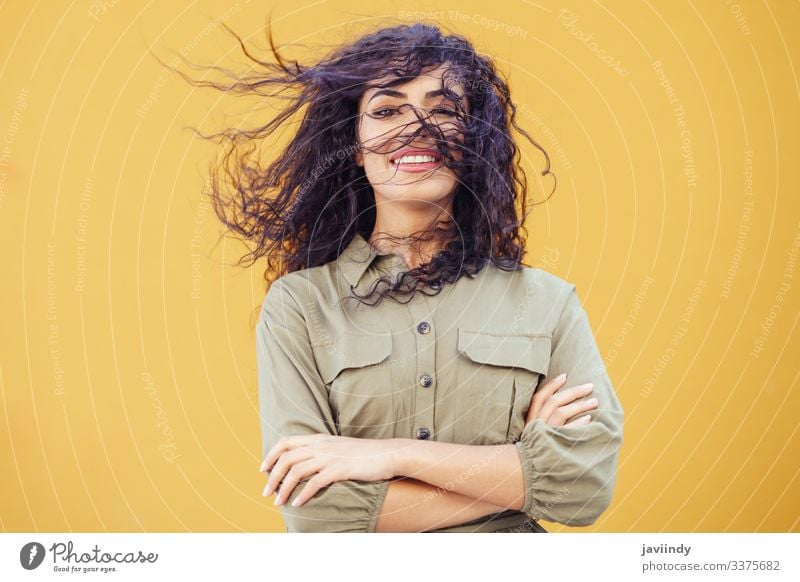 Arab Woman with curly hair in her face woman arab hairstyle smile beautiful girl beauty young one fashion female arabic copyspace middle eastern yellow green