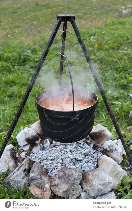 https://www.photocase.com/photos/3376078-goulash-beeing-cooked-in-a-cauldron-over-an-open-fire-on-a-picnic-dot-photocase-stock-photo-large.jpeg
