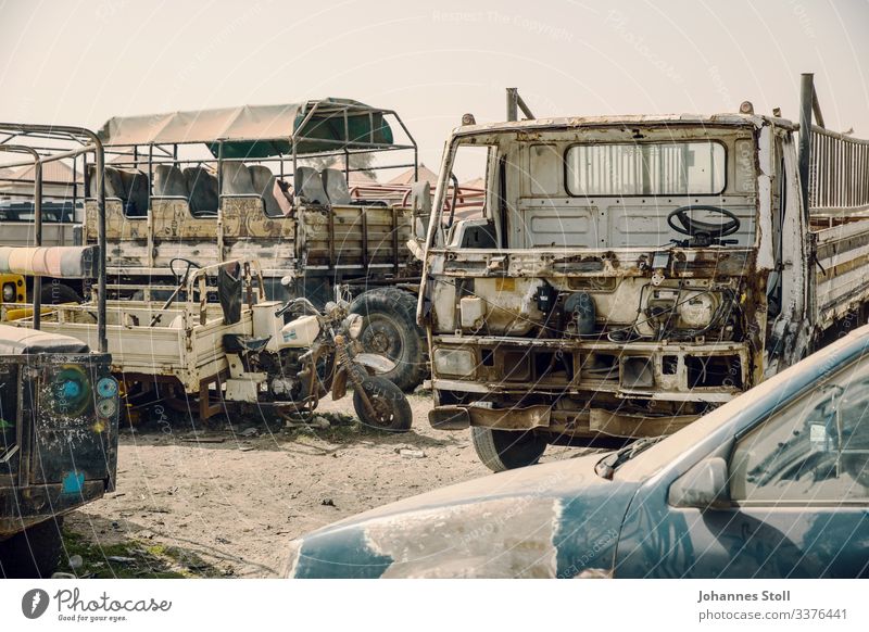 Rusty wrecks at car graveyard in Africa junkyard Wrecked car Dismantle metal Iron Steel Recycling waste Disposal storage repositories Sand Desert Senegal Truck