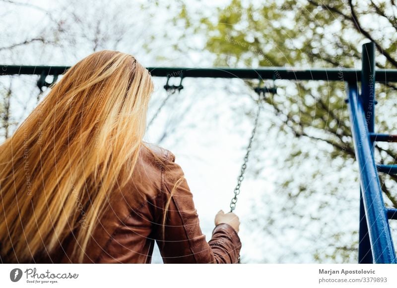 Young woman on a swing on a playground Lifestyle Joy Freedom Human being Feminine Youth (Young adults) Woman Adults 1 30 - 45 years To enjoy To swing Happiness