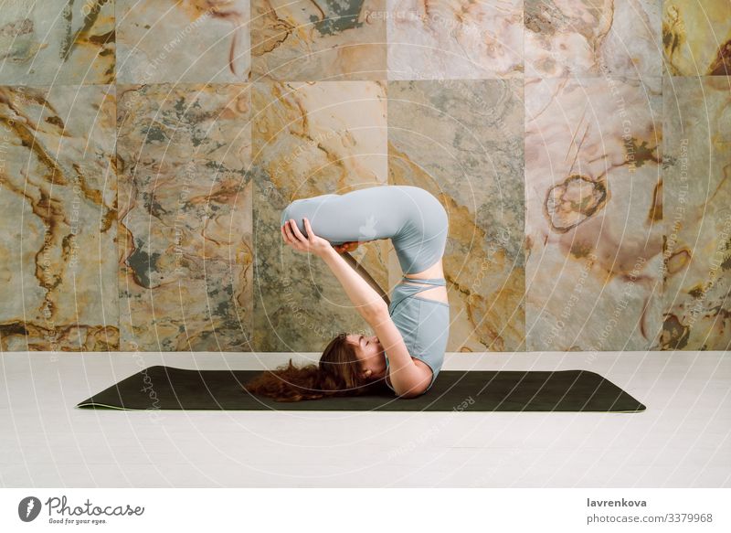 Yogini practising Urdhva padmasana pose, selective focus mindfulness active athletic body brunette calm caucasian exercise female flexible girl leisure