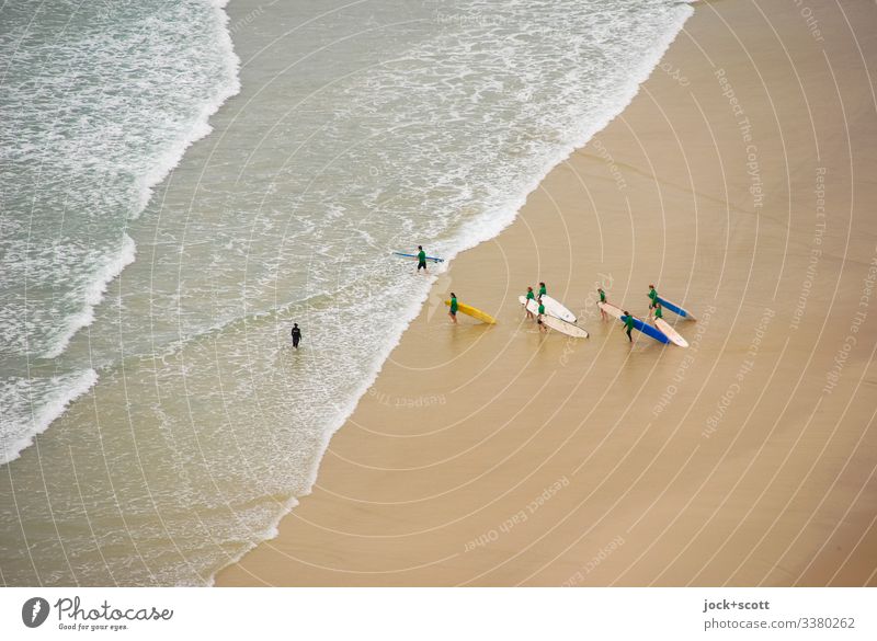 Surfers run together against the surf into the sea Pacific Ocean Waves Vacation & Travel Bird's-eye view Sunlight Beach life Society Freedom Experience Together