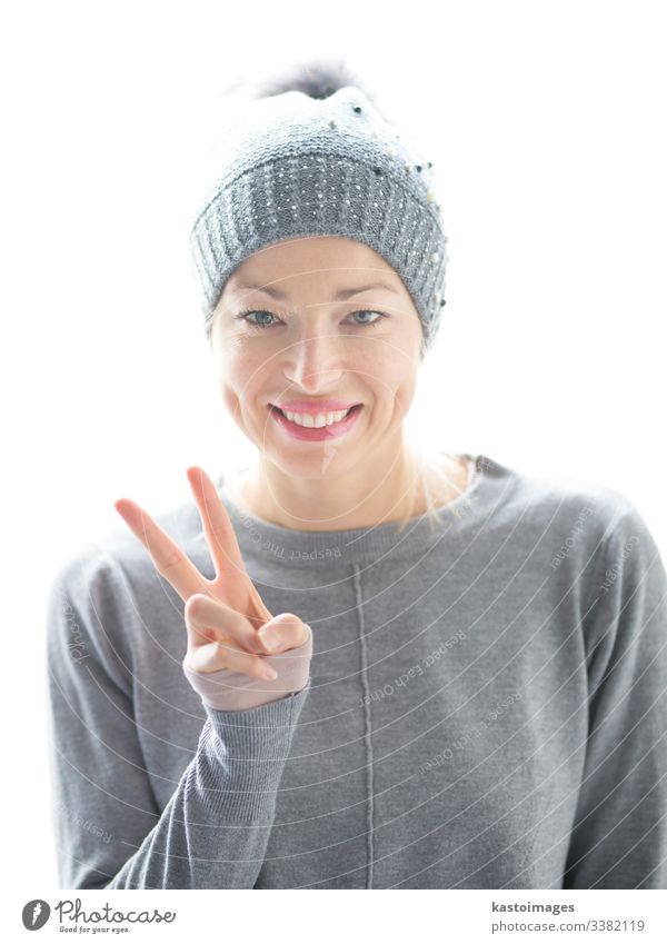 Close up portrait of cheerful caucasian woman, gesturing peace sign and smiles girl beautiful female happy hat white hand casual fun gesture playful joy student