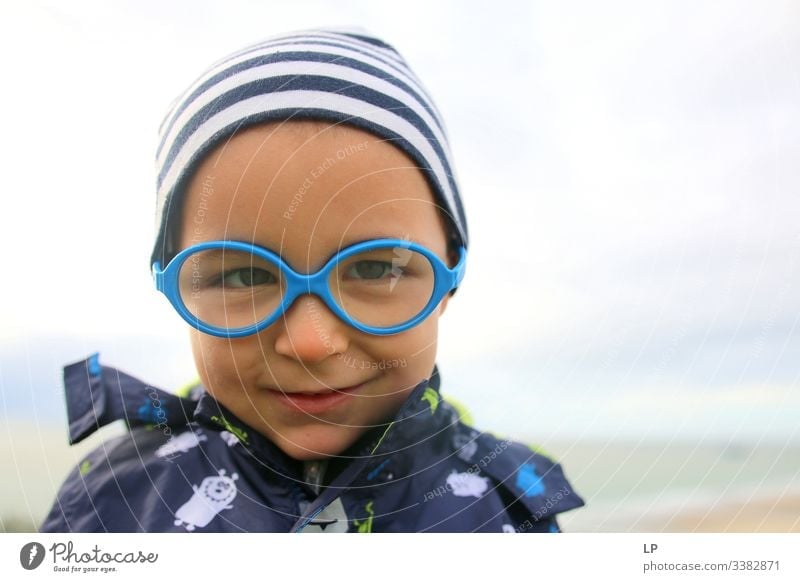 lovely child wearing glasses looking into the camera mindfulness Children's game Childhood memory Childhood wish Childhood dream inocence happiness,emotion