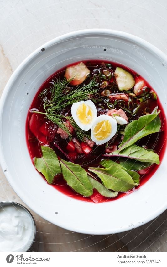 Colorful beetroot soup with eggs and herbs in plate green delicious food tasty fresh dish cuisine meal vegetable bowl healthy gourmet ingredient nutrition