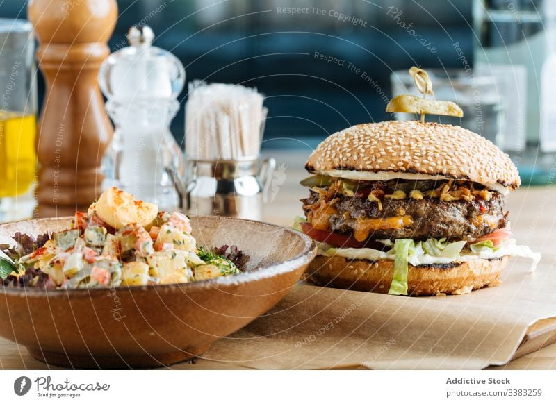 Classic burger and salad in restaurant dish cafe patty cutlet colorful vegetable sauce cheese modern bowl roast garnish rustic classic prepare appetizer fried