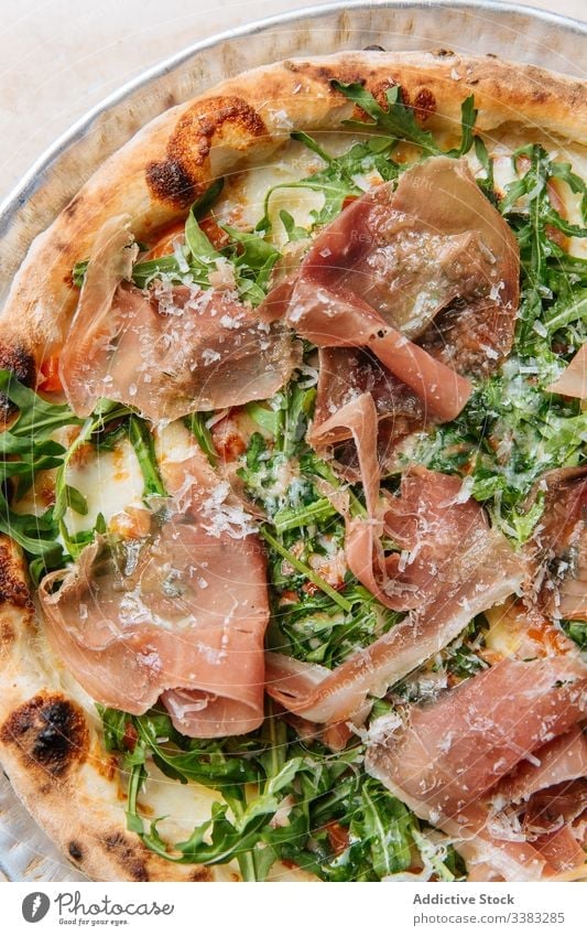 Delicious pizza with meat in restaurant bacon herb greenery dough baked italian food meal cuisine tasty lunch fresh table delicious tradition prepare dish snack