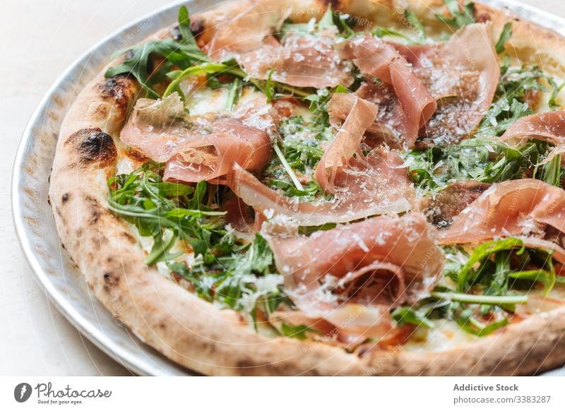 Delicious pizza with meat in restaurant bacon herb greenery dough baked italian food meal cuisine tasty lunch fresh table delicious tradition prepare dish snack